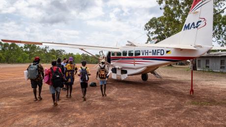 Yolngu studetns walking to MAF plane