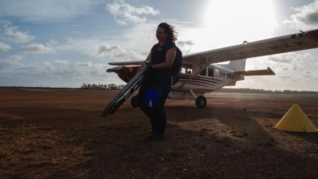 MAF staff carrying medical equipment from aircraft
