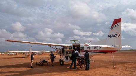 Aircraft and ambulance stretcher on tarmac