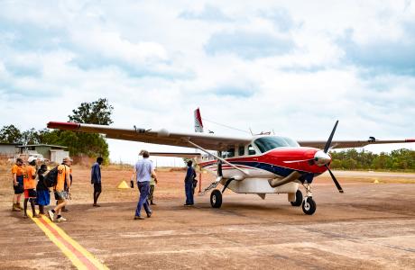 Pilot and scheduled flight service passengers walking out to aircraft