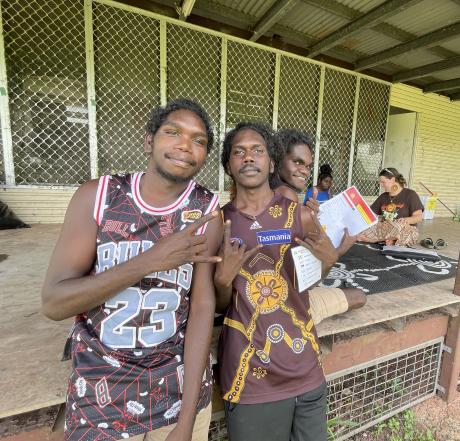 Laynhapuy Homelands School friends Dhunggala, Yalanba and Vernon outside a classroom in Gurrumuru with teacher Sophie Grambeau and student Bangulnga in the background.