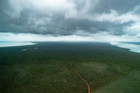 Lonely road into stormy landscape