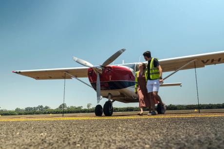 Young couple with GA8 aircraft on tarmac