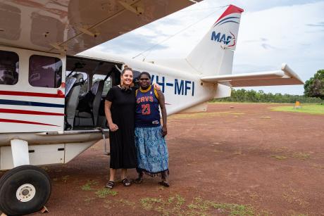 Teacher and Homeland Teacher in front of MAF aircraft