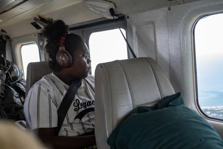 Student teacher in aircraft looking out of the window