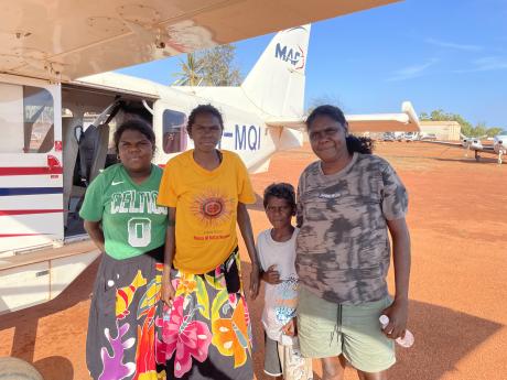 People standing in fromnt of aircraft