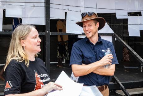 Womanm and man speaking outside school building