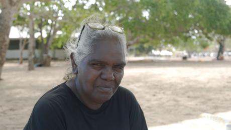 Yolgu lady in the shade of a tree