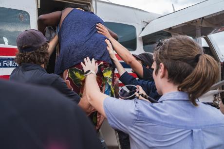 Patient being helped to board aircraft
