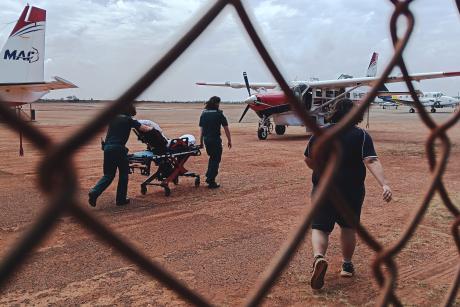 Paramedics wheeling starecther to aircraft