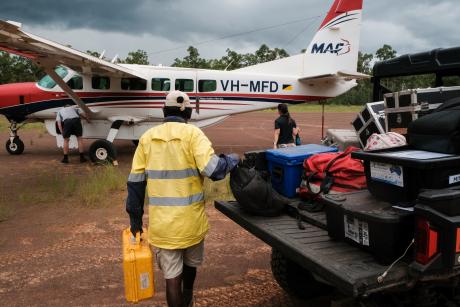 loading aircraft on red dirt airstrip