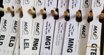 MAF luggage tags on a rack